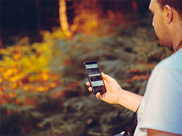 Man with phone stuggling to get a signal